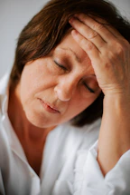 a woman holding her head in her hands