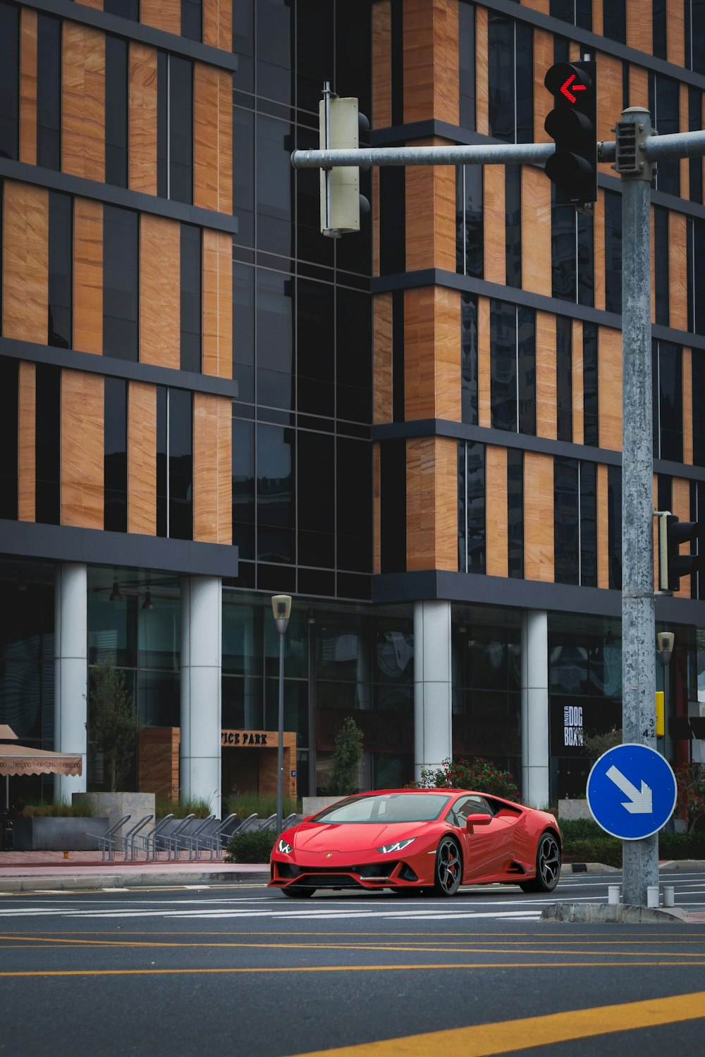 a red sports car is stopped at a traffic light