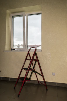 A versatile expandable aluminium ladder extended outdoors on a sunny day.