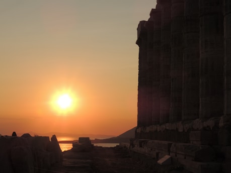 Cover of 'Age of the Crimson Sun' book with a fiery sunset and ancient ruins.