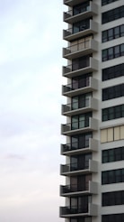 a tall white building with balconies and balconies