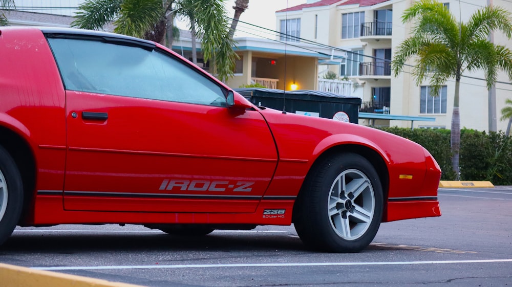 a red sports car parked in a parking lot