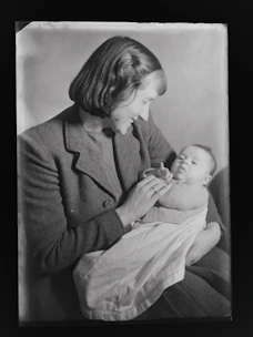 A warm and welcoming mom holding a baby surrounded by popular baby products.