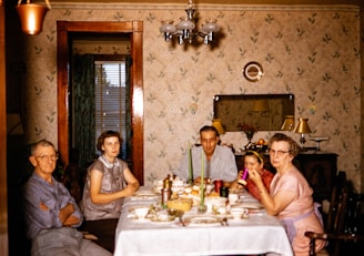 a group of people sitting around a dinner table