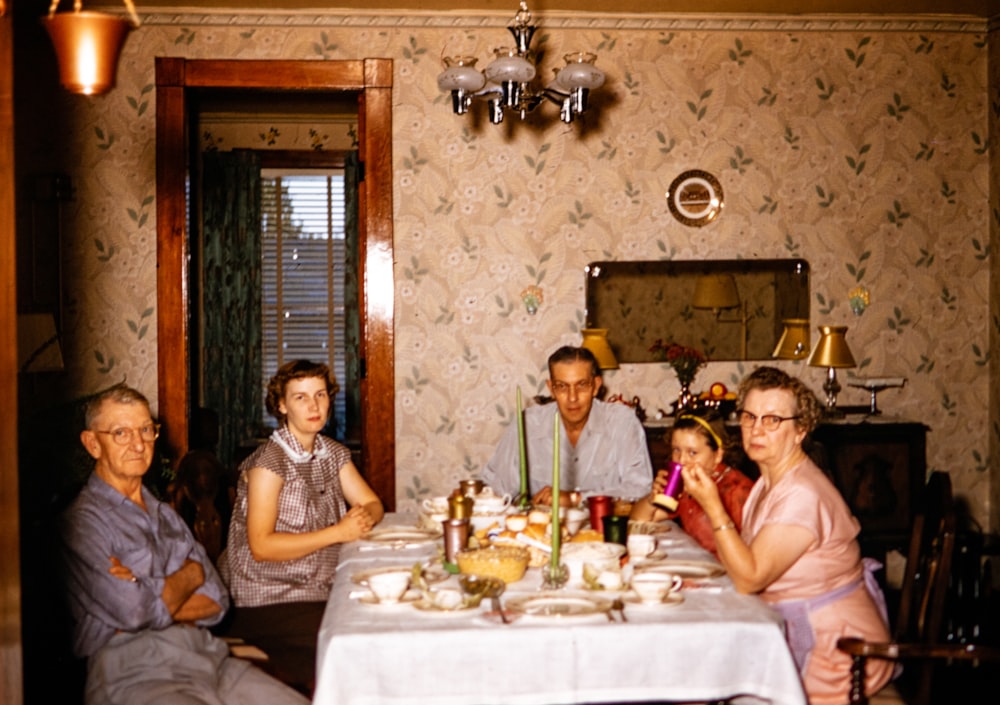 a group of people sitting around a dinner table