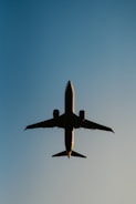 a large jetliner flying through a blue sky