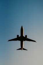 a large jetliner flying through a blue sky