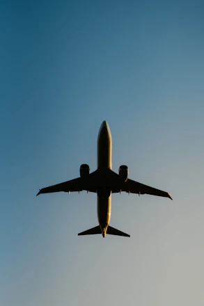 a large jetliner flying through a blue sky