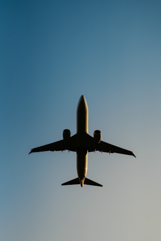 a large jetliner flying through a blue sky