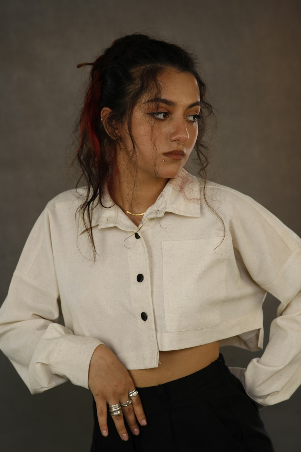 a woman wearing a white shirt and black pants