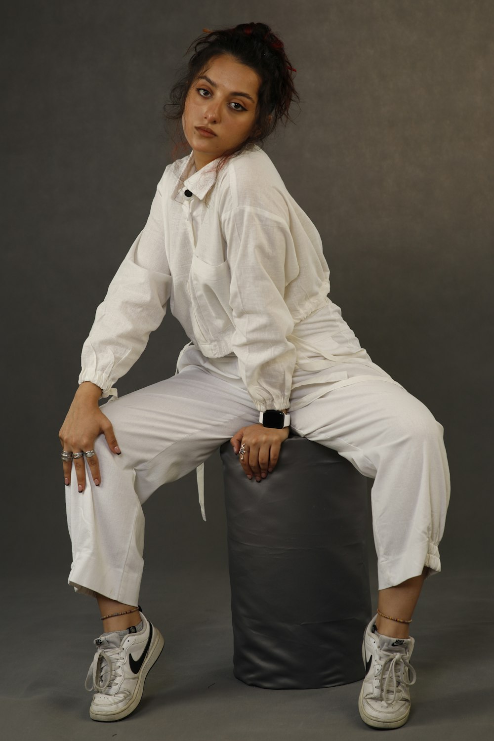 a woman sitting on top of a black bag