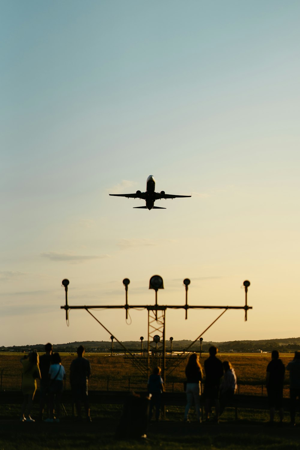 a plane is flying over a group of people