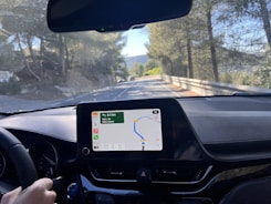 Professional driver checking a digital route map on a tablet inside the vehicle