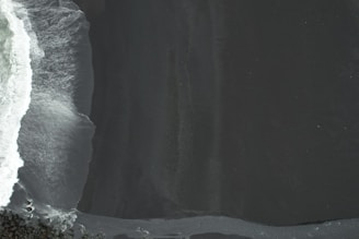 a person riding a snowboard down the side of a snow covered slope