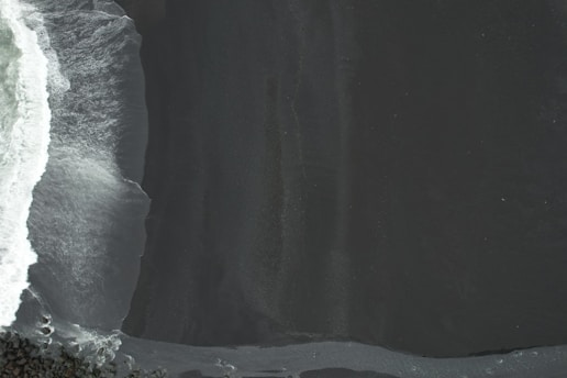 a person riding a snowboard down the side of a snow covered slope