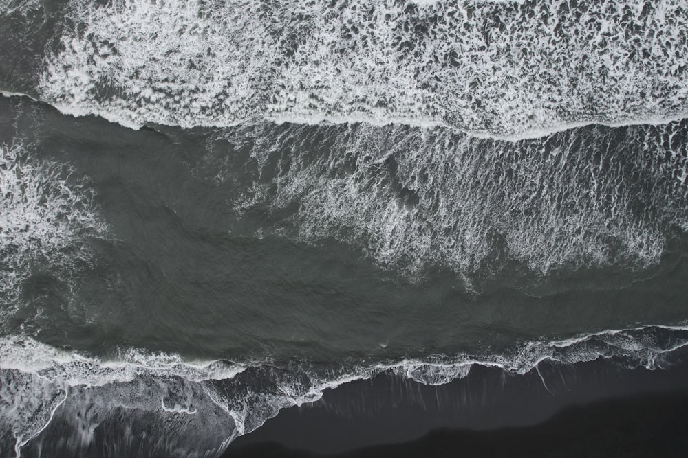 a black and white photo of the ocean waves