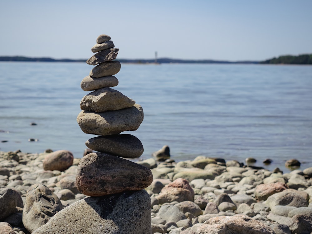 a stack of rocks sitting on top of a rocky beach