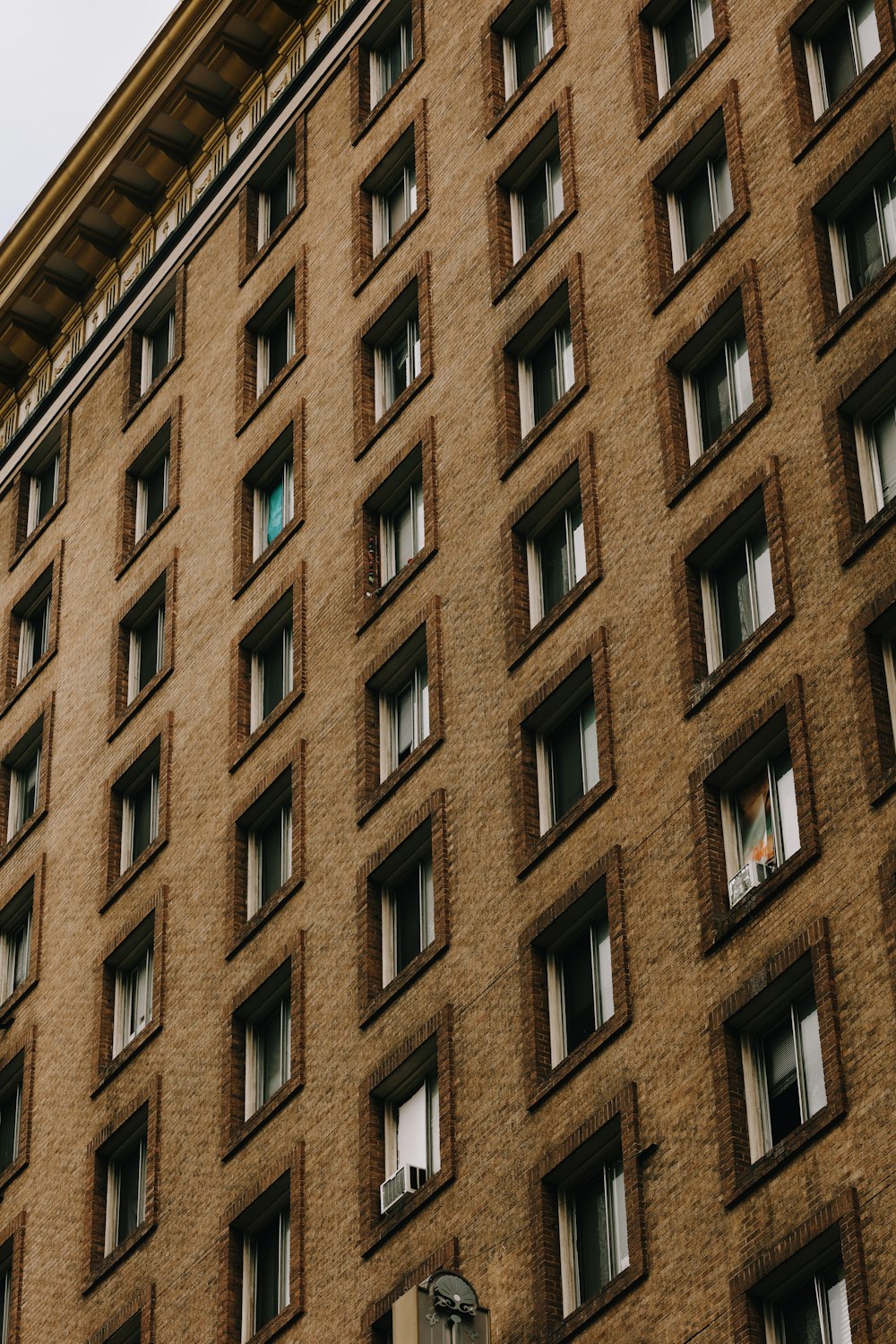 a tall brown building with lots of windows