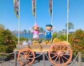 Artistic depiction of children surrounded by iconic cultural symbols like pyramids and classical statues.