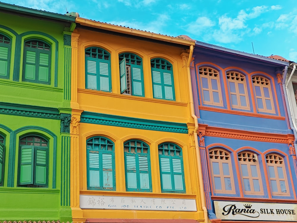 a row of multicolored buildings on a street