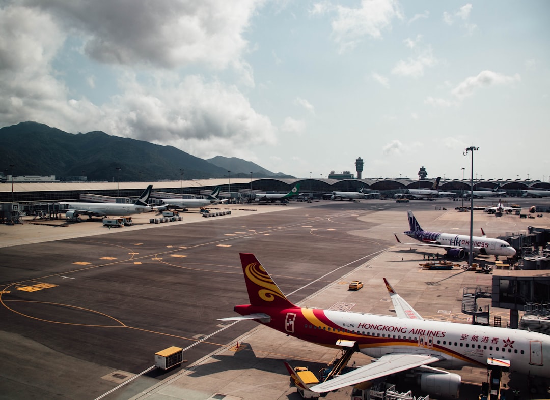 a large jetliner sitting on top of an airport tarmac, Hong Kong International Airport
