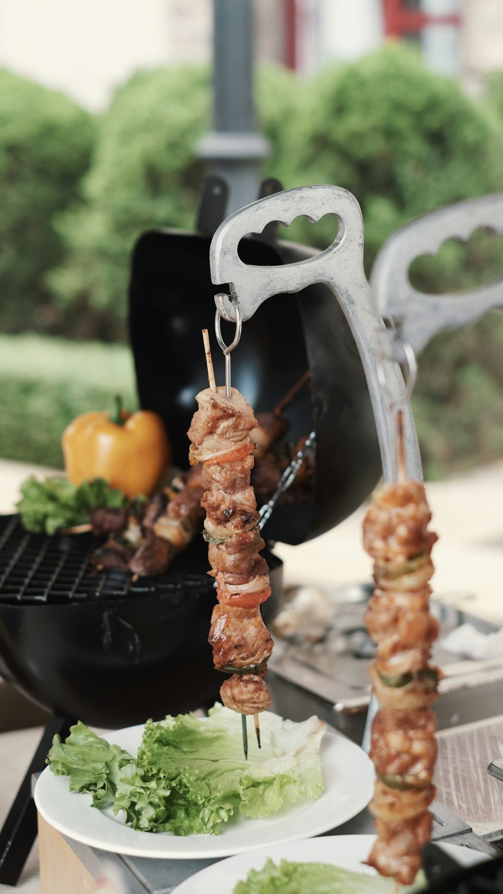 a couple of skewers of food on a grill