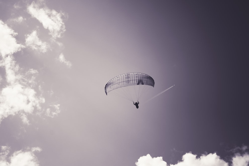 a person is parasailing in a cloudy sky