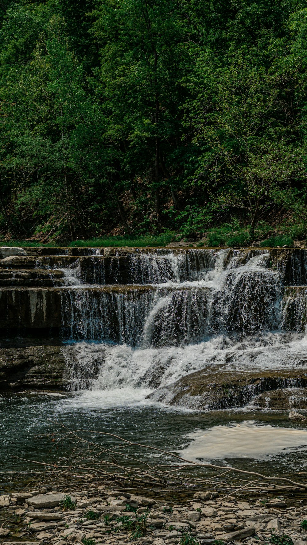 a man is standing in front of a waterfall