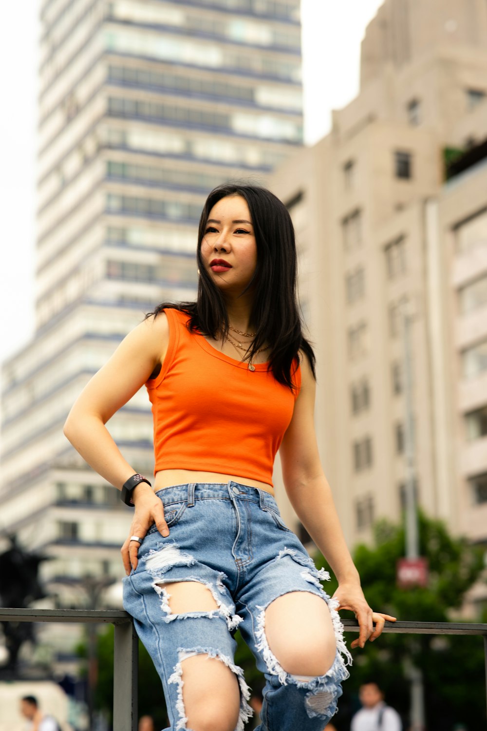 a young woman posing for a picture in a city