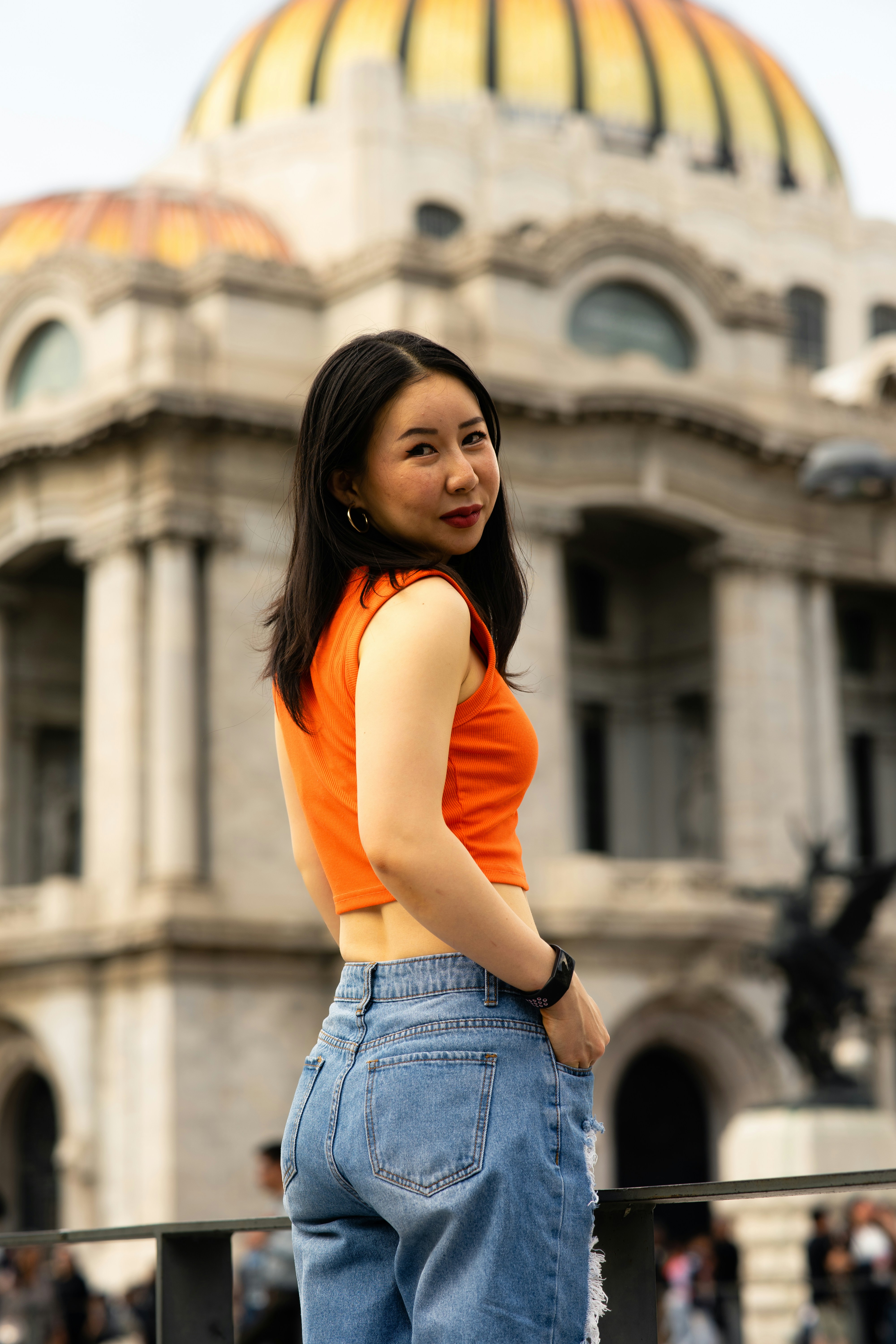 Happy young Asian woman visiting the streets of Mexico City.