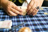 Close-up of a skilled artisan folding a fresh paper cup with care.