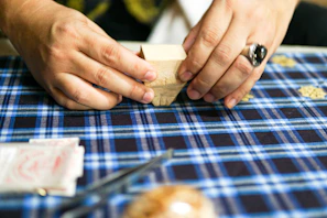 Close-up of a skilled artisan folding a fresh paper cup with care.