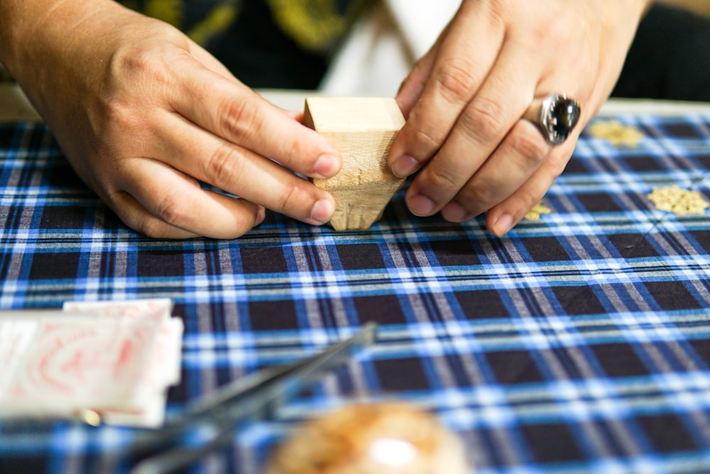 a close up of a person carving a piece of wood