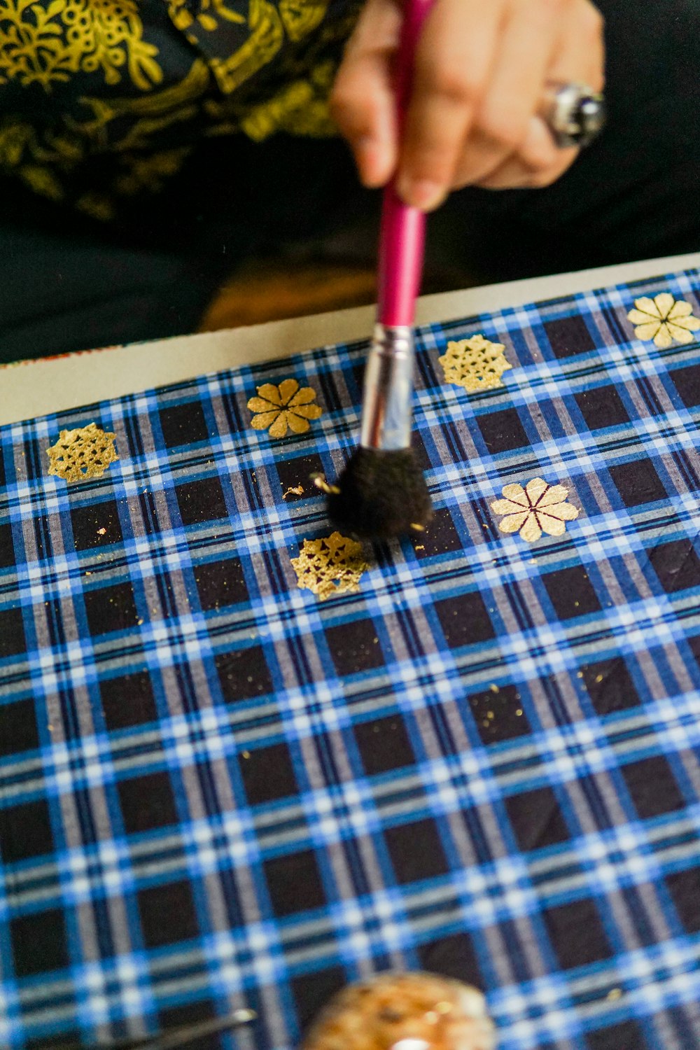 a close up of a person using a brush on a table