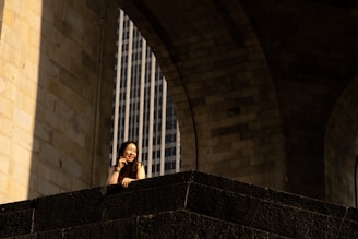 Smiling customer standing beside a construction site with elegant stone finishes.