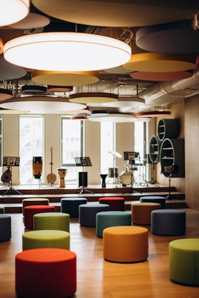 A warm, inviting music classroom with instruments and artwork displayed.