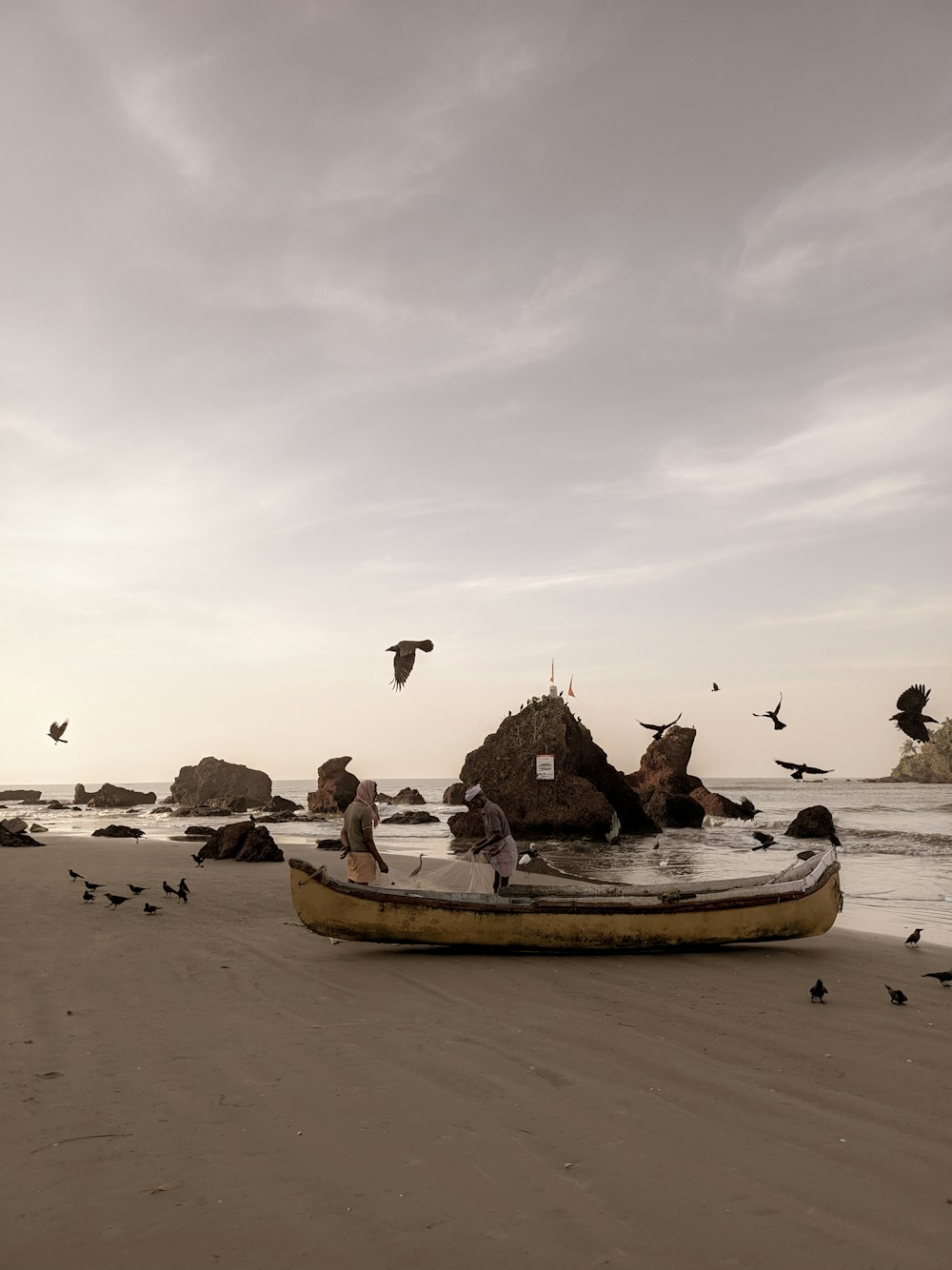 a boat sitting on top of a sandy beach