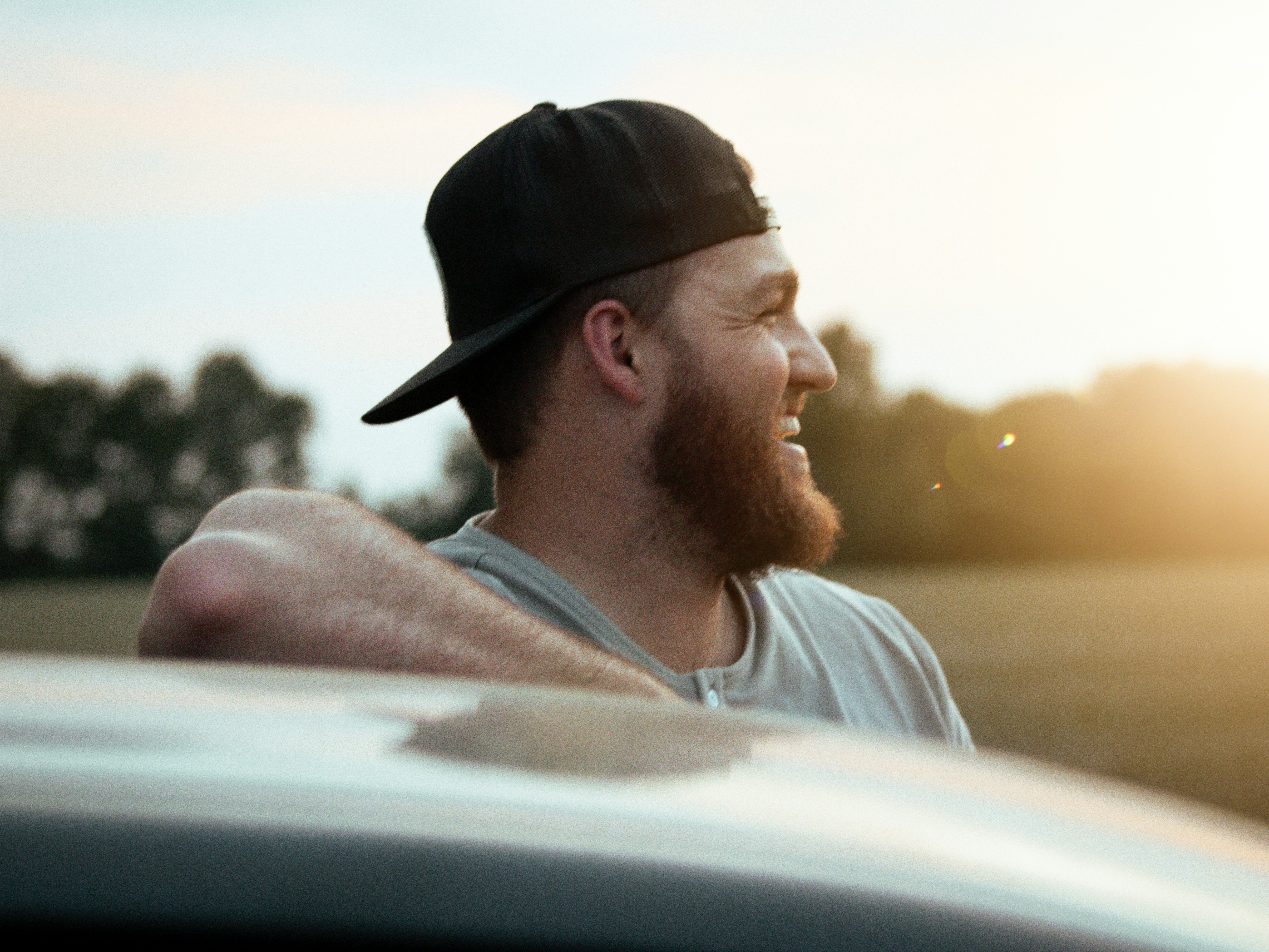 a man with a beard wearing a black hat