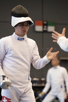 A vibrant fencing training session with coaches and athletes.