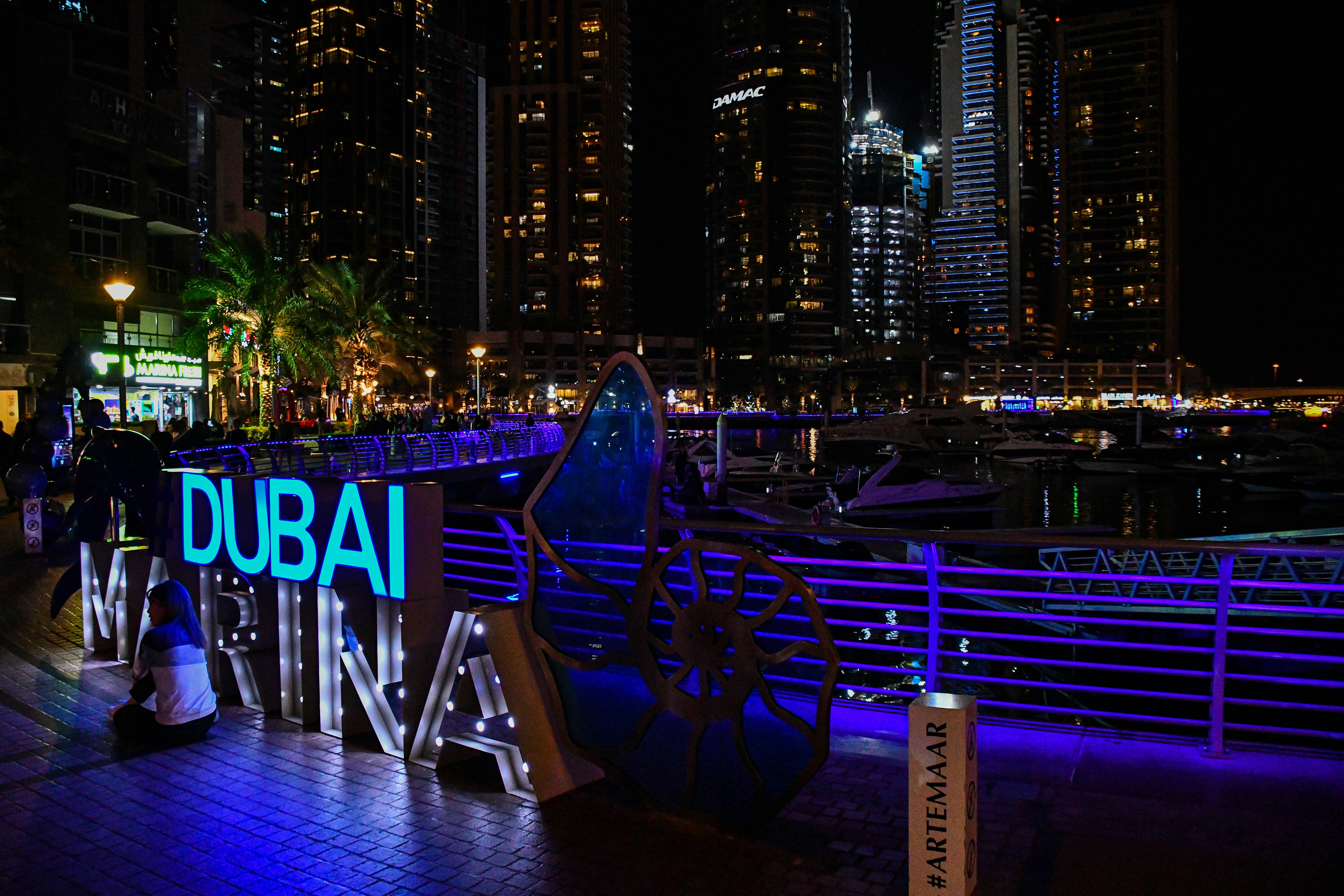 Dubai Marina skyline with tall towers at night, luxury tech hub in the Middle East