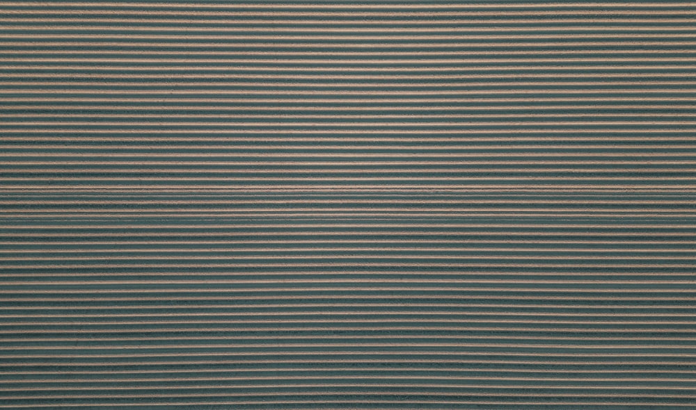 a blue and beige rug with horizontal stripes