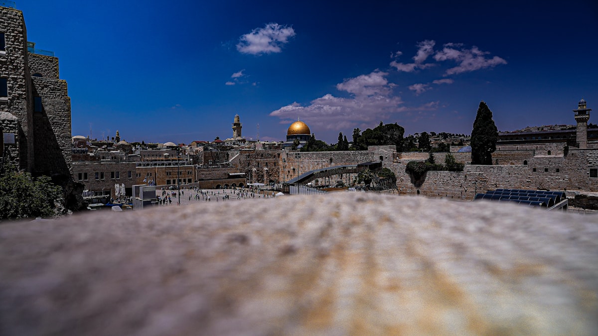 Old City Jerusalem — rooftop view across the ancient stone buildings toward the Dome of the Rock