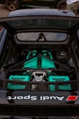 the engine compartment of a sports car parked in a parking lot