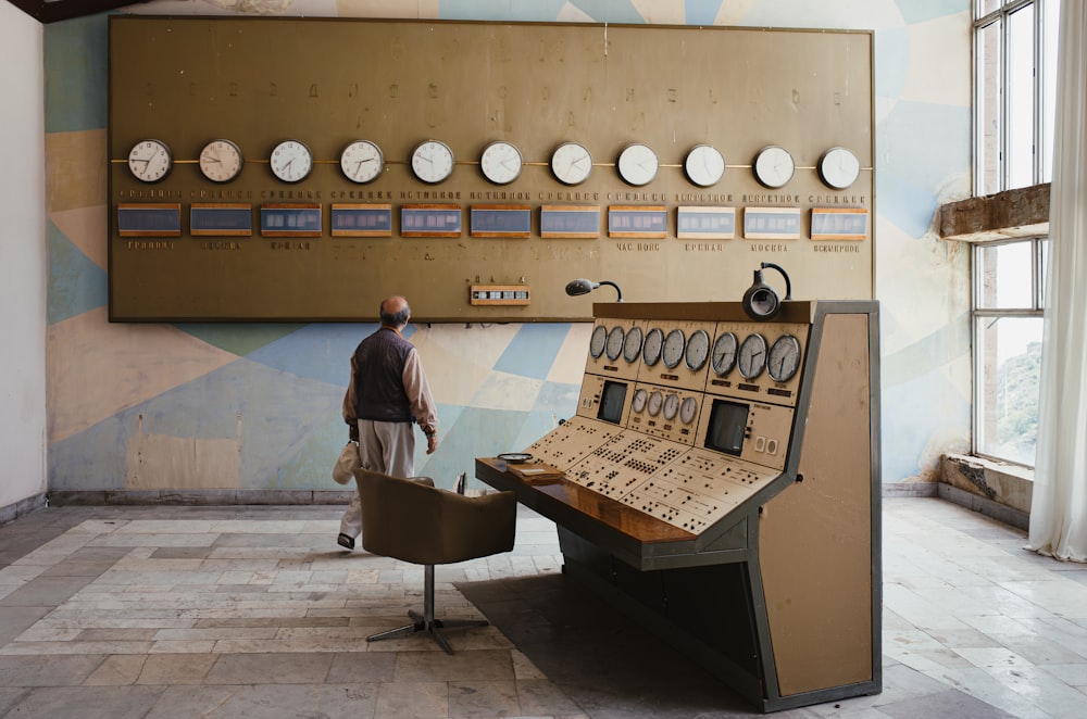 a man standing in front of a control panel