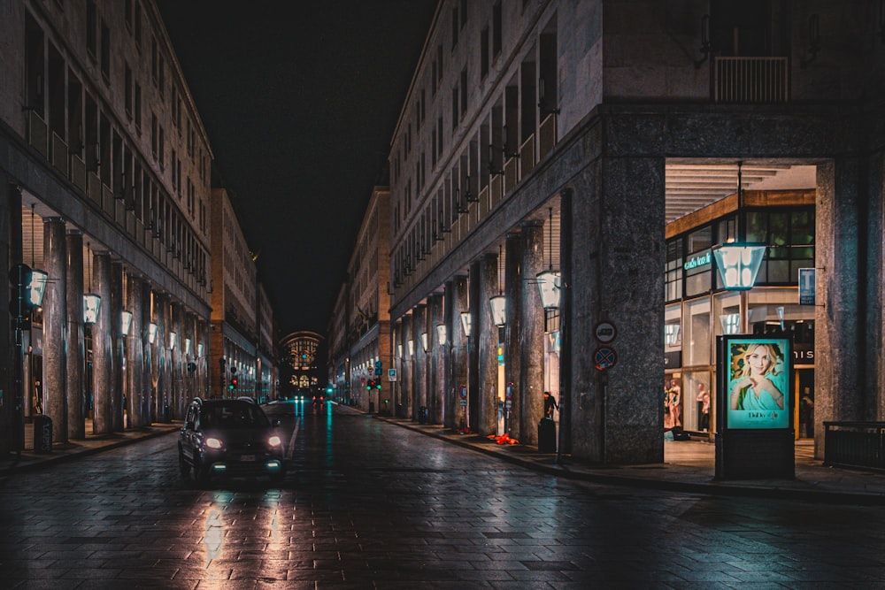 a car driving down a street at night