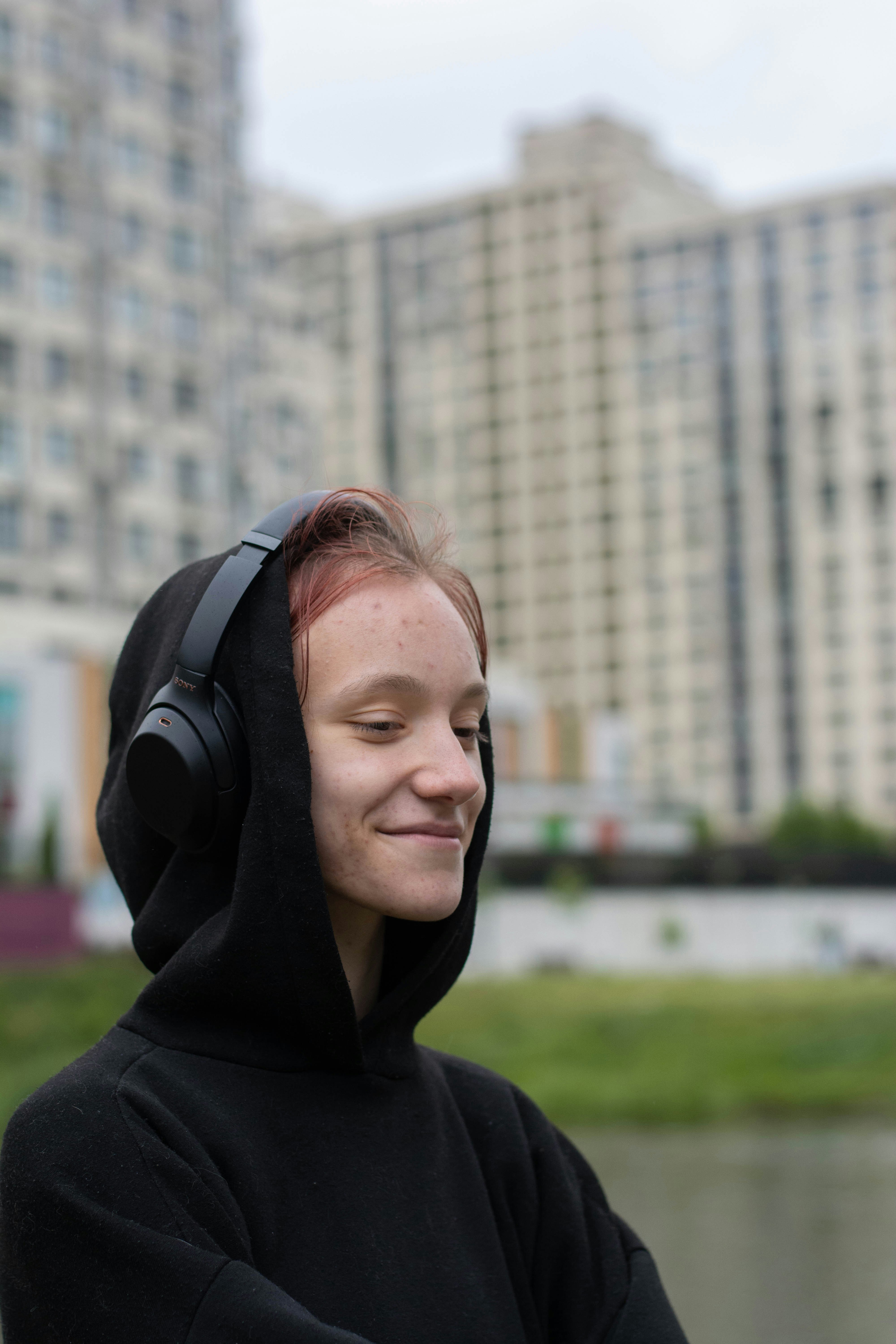 a woman in a black hoodie with headphones on