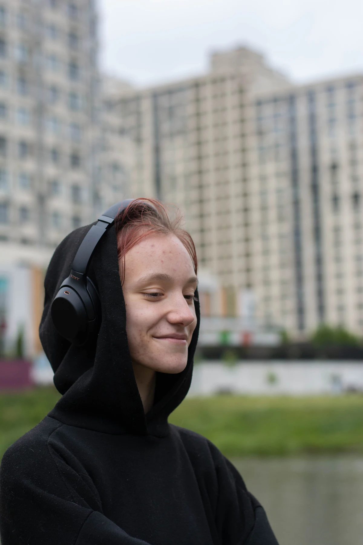 A woman listening through headphones with her eyes closed
