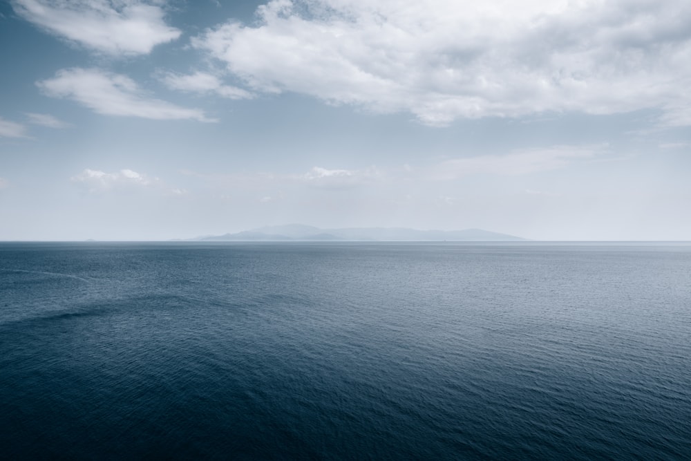 a large body of water under a cloudy sky