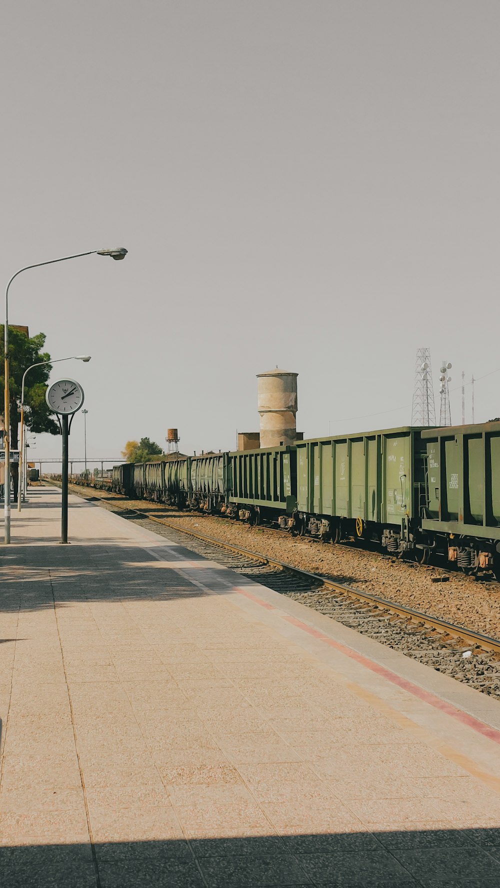 a train traveling down train tracks next to a train station