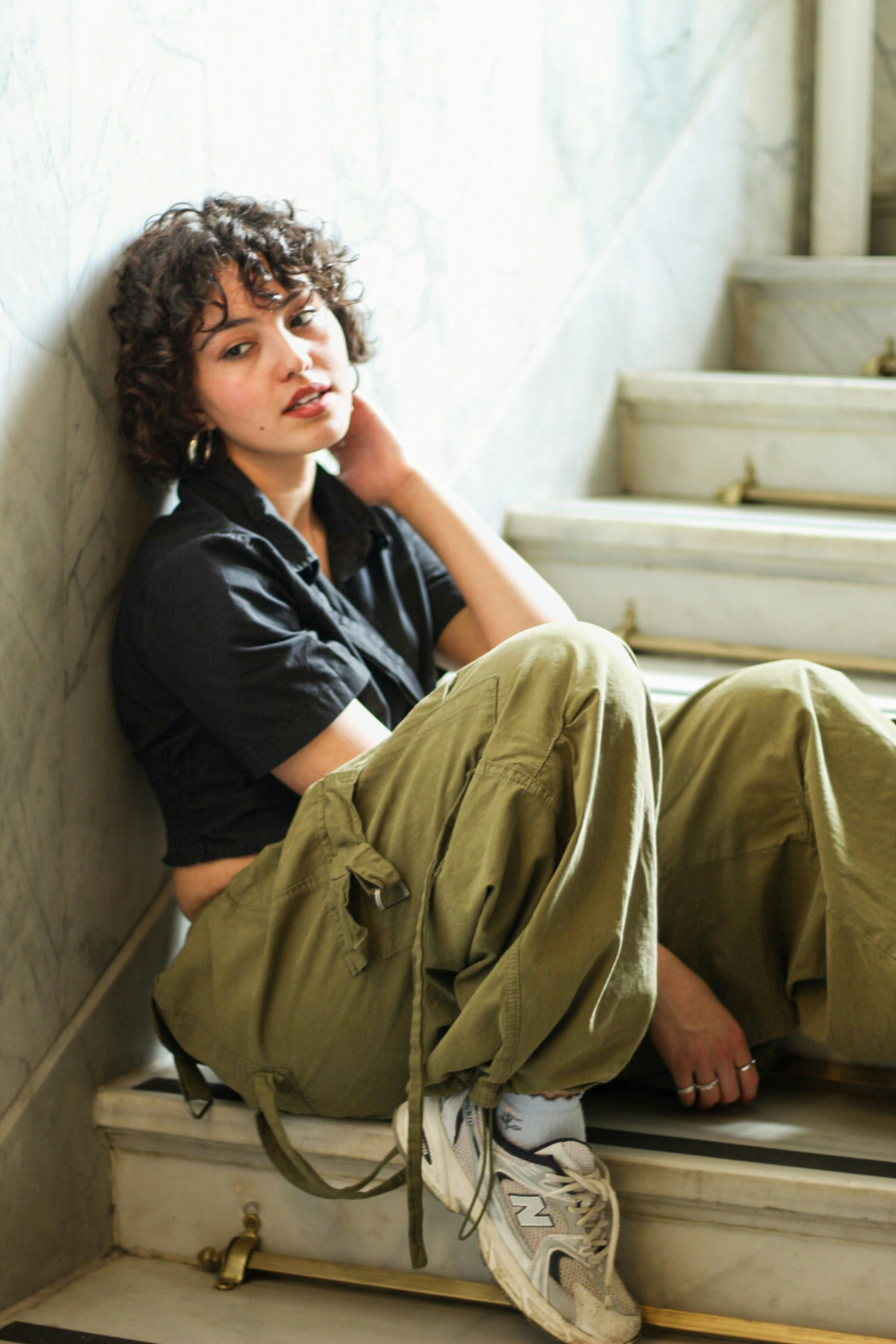 Relaxed fit cargo pants in olive green, cuffed at ankle, minimal background